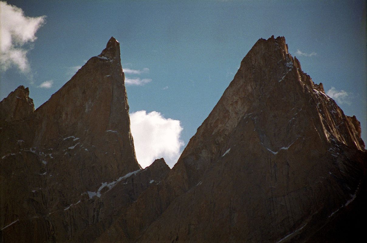 20 Lobsang Spire From Khoburtse Just After Sunrise The early morning sun shines on Lobsang Spire (5707m) from Khoburtse. Lobsang Spire was first climbed on June 13, 1983 alpine style by Doug Scott, Greg Child, and Pete Thexton. Its featureless up there. Impossible, says Doug. 
Out comes the drill. 
 For two hours I hammer away on the fifteenth pitch, interspersing rivets with sequences of skyhooks balanced on tiny edges, in order that our ten rivets might last the 100 ft to the summit. When I step onto the final skyhook placed on the lip of the knife-edged summit I grab a handful of snow and sprinkle it onto Pete And Doug below. A present from the summit, I shout. - Thin Air: Encounters in the Himalayas by Greg Child.